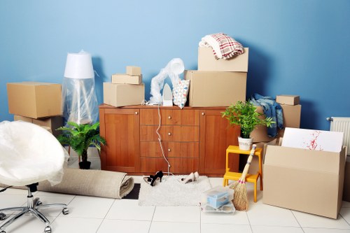 Local removals van helping with boxes and household items in East London