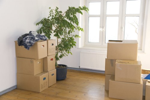 Business relocation preparation with boxes, desks, and labelled equipment