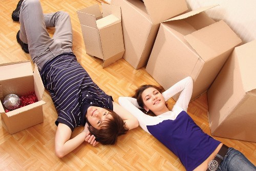 Local removals team loading household items into a van