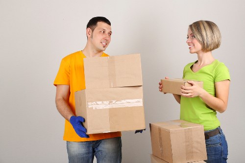 Local moving team handling boxes and household items near Upton Park